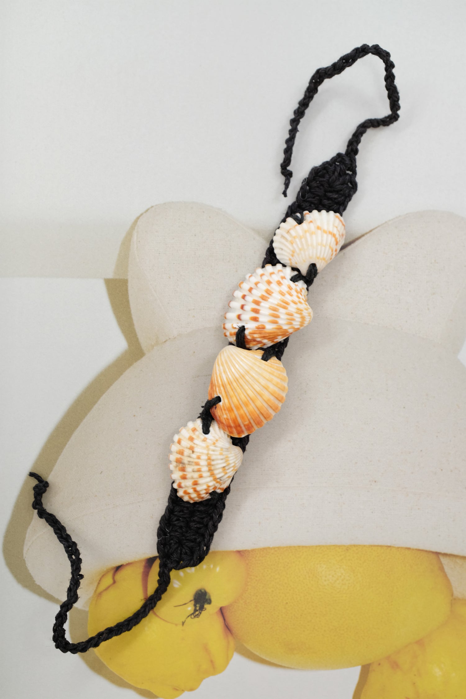Necklace with shell beads on a white background. Shell & Hemp Bracelet.