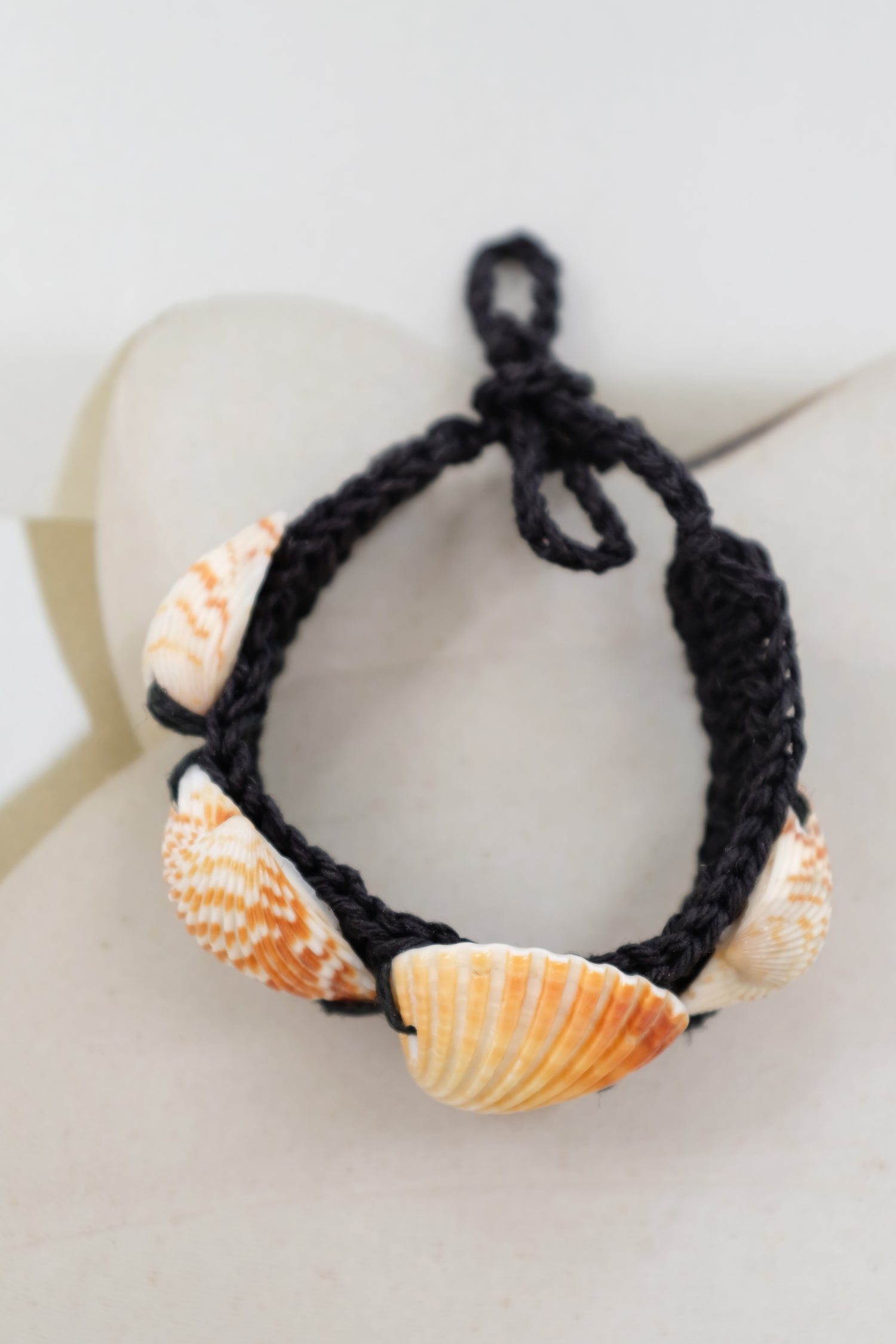 Necklace with shell beads on a white background. Shell & Hemp Bracelet.